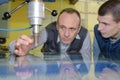 Engineer and apprentice using automated milling machine Royalty Free Stock Photo