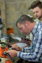 Engineer and apprentice working on machine in factory Royalty Free Stock Photo