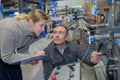 engineer and apprentice working on machine in factory Royalty Free Stock Photo