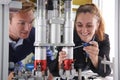 Engineer And Apprentice Working On Machine In Factory Royalty Free Stock Photo