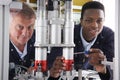 Engineer And Apprentice Working On Machine In Factory Royalty Free Stock Photo