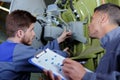 Engineer with apprentices checking antena