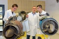 Engineer and apprentices fixing airplane propellers