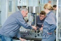 engineer and apprentices using automated milling machine Royalty Free Stock Photo