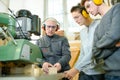 engineer and apprentices using automated milling machine Royalty Free Stock Photo