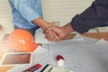 Engineer and Architect concept, Engineer Architects office team working shaking hand with blueprints and house model on office des Royalty Free Stock Photo