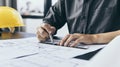 Engineer and Architect concept, Man uses a ruler to measure the floor plan on the blueprint Royalty Free Stock Photo