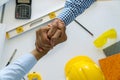 Engineer Architect concept. Two construction engineers finished working shaking hands on table office with blueprints Royalty Free Stock Photo
