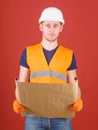 Engineer, architect, labourer, builder on strict face holds old blueprint in hands. Man, handyman in helmet, hard hat Royalty Free Stock Photo