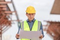 Engineer or architect man in hard hat holding a blueprint at construction site, Construction worker holding plan Royalty Free Stock Photo