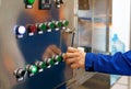 Engineer in blue suit works with control panel, work in the laboratory Royalty Free Stock Photo