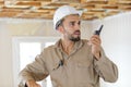 engineer builder in hardhat using mobile walkie talkie Royalty Free Stock Photo