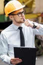 Engineer builder in a helmet holds folder at construction site Royalty Free Stock Photo