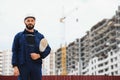 Engineer builder wearing safety vest with blueprint at construction site Royalty Free Stock Photo