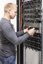 IT engineer builds network rack in datacenter Royalty Free Stock Photo