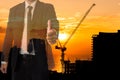 Engineer or businessman thumbs up gesture with silhouette of construction site crane Royalty Free Stock Photo