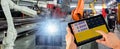 Engineer check and control welding robotics automatic arms machine in intelligent factory automotive industrial with monitoring