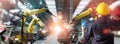 Engineer check and control welding robotics automatic arms machine in intelligent factory automotive industrial with monitoring