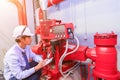 Engineer check red generator pump for water sprinkler piping and fire alarm control. Royalty Free Stock Photo