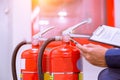 Engineer checking fire extinguisher. Royalty Free Stock Photo