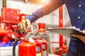 Engineer checking Industrial fire control system,are checking fire extinguishers. Royalty Free Stock Photo