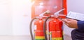 Engineer are checking and inspection a fire extinguishers tank in the fire control room for safety training and fire prevention Royalty Free Stock Photo