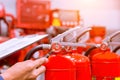 Firefighter checking pressure gauge level of fire extinguisher tank in the building concepts of protection and prevent for emergen