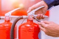 Engineer checking fire extinguisher. Royalty Free Stock Photo