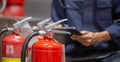 Engineer are checking and inspection a fire extinguishers tank in the fire control room for safety training and fire prevention Royalty Free Stock Photo