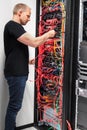 IT engineer checking with network cables connected to servers