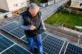 Engineer checking solar panel setup. Using smart app in tablet Royalty Free Stock Photo