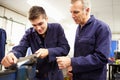 Engineer Checking Trainee's Work On Factory Floor