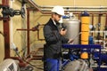 Engineer checks scheme pipelines on industrial factory