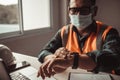 Engineer checks the time by looking at a smartwatch