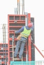 An engineer is climbing up the stairs at the constraction site