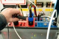 Engineer connecting test plug to electrical device for testing relay