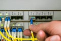 The engineer connects the optical Internet cable with the central router module in the server room of the data center. The front Royalty Free Stock Photo