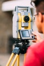 engineer on construction site, working with total station theodolite and gps system