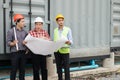 Engineer and construction team wearing safety helmet and blueprint on hand. they are checking construction process Royalty Free Stock Photo