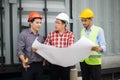 Engineer and construction team wearing safety helmet and blueprint on hand. engineer and client checking construction process Royalty Free Stock Photo