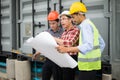 Engineer team wearing safety helmet and blueprint on hand. they are working on checking progress of construction site Royalty Free Stock Photo