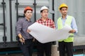 Engineer and client wearing safety helmet and blueprint on hand. they are working on checking progress of construction site. Royalty Free Stock Photo