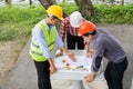 Engineer and construction team wearing safety helmet and looking blueprint on the table. Royalty Free Stock Photo