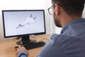 Engineer, Constructor, Designer in Glasses Working on a Personal Computer. He is Creating, Designing a New 3D Model of Aircraft,