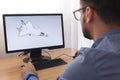 Engineer, Constructor, Designer in Glasses Working on a Personal Computer. He is Creating, Designing a New 3D Model of Aircraft,