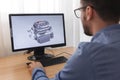 Engineer, Constructor, Designer in Glasses Working on a Personal Computer. He is Creating, Designing a New 3D Model of Car Engine Royalty Free Stock Photo