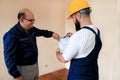 Engineer, contractor and project manager with their colleague construction worker with construction apartment blueprint. Royalty Free Stock Photo