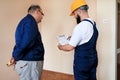 Engineer, contractor and project manager with their colleague construction worker with construction apartment blueprint. Royalty Free Stock Photo