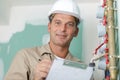 Engineer controlling heating pipes at boiler room