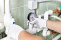 Engineer controlling the heating pipes at the boiler room. Royalty Free Stock Photo